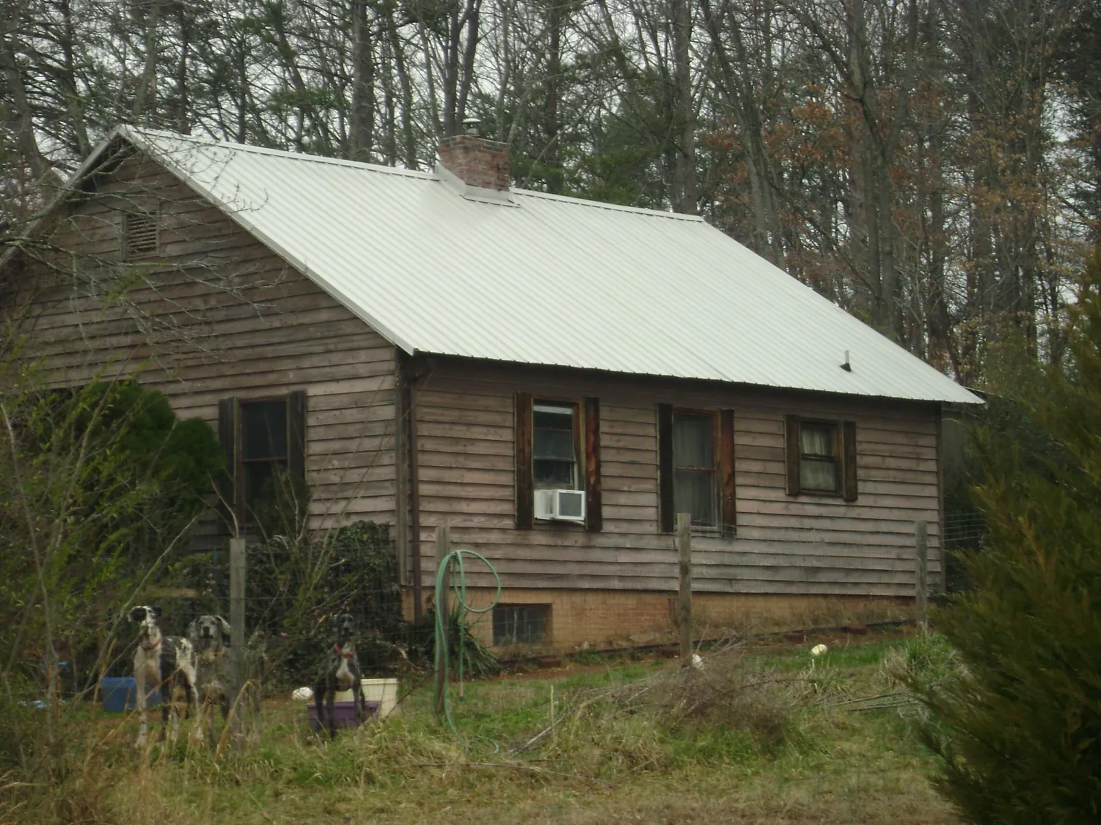 White metal roof on an old wood sided farmhouse, from a Metal Roof Installation job in North Smithfield